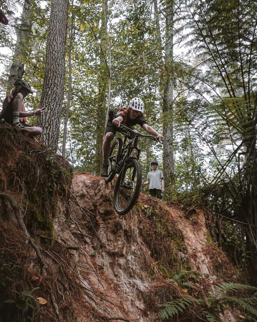 mountain biker dropping off steep slope