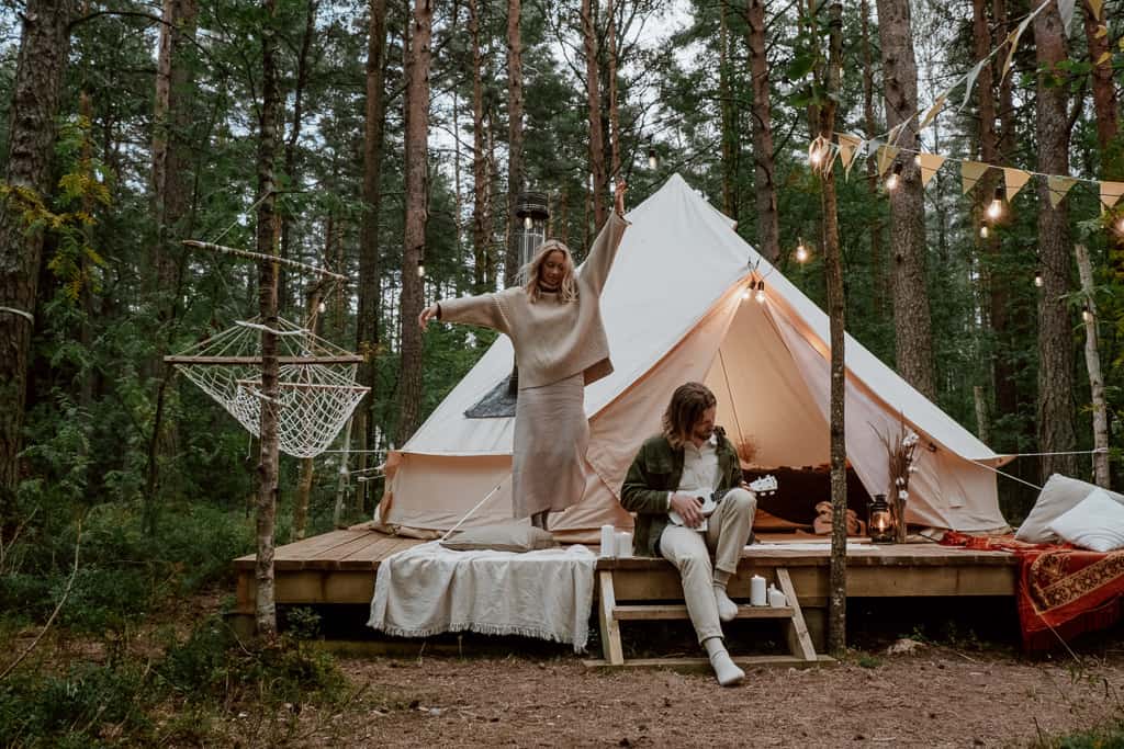 couple enjoys a glamping experience in the forest