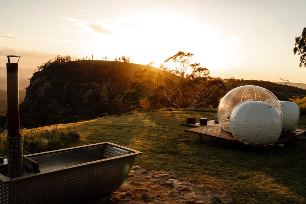 outdoor bathtub and bubble tent with view.