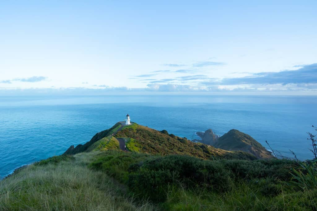 view of cape reinga lighthouse from high viewpoint