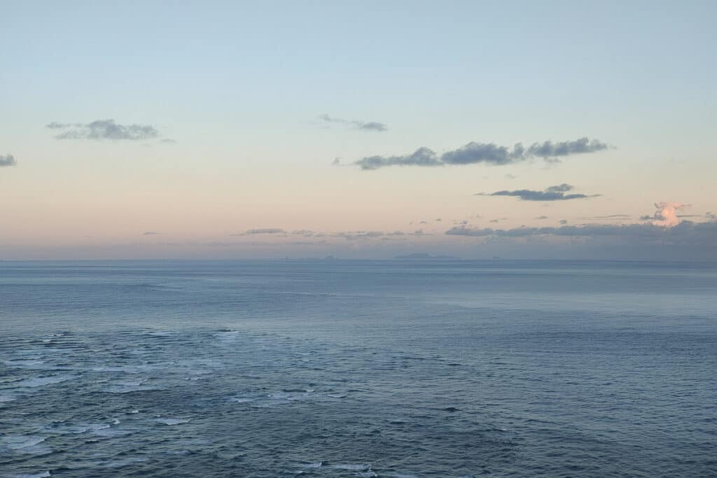 view of meeting of the oceans and three kings island from cape reinga